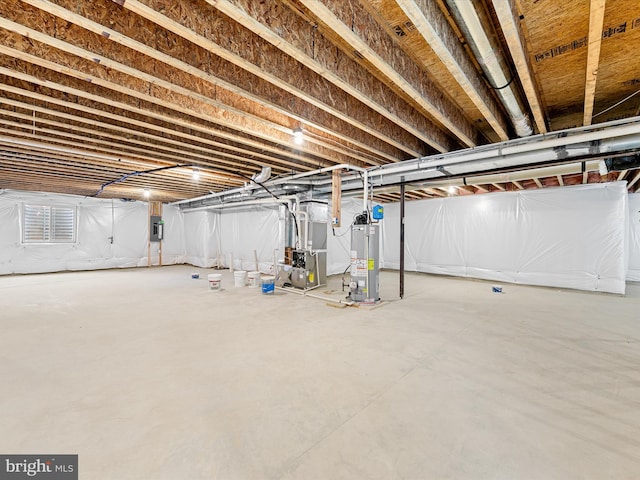 basement featuring gas water heater, electric panel, and heating unit