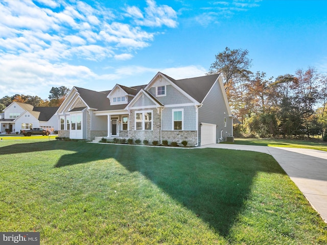 craftsman-style house featuring a front yard, a porch, and a garage