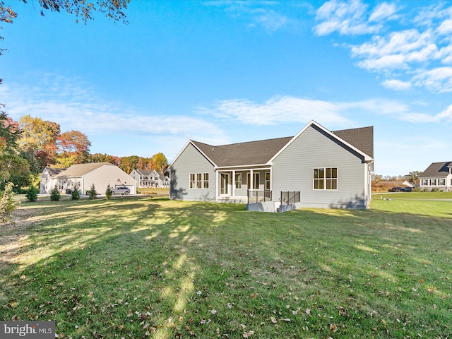 back of property featuring a lawn and a porch