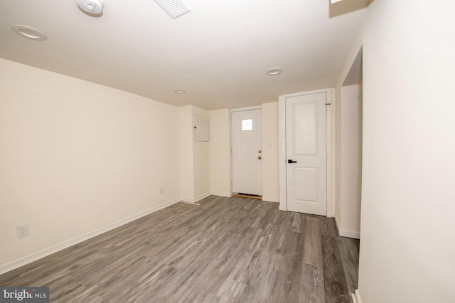 spare room featuring wood-type flooring