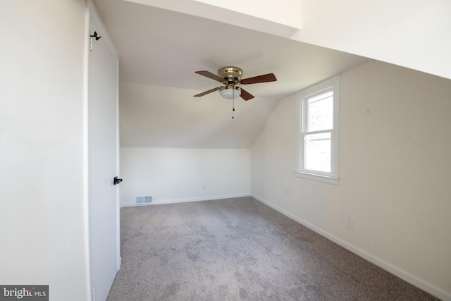 additional living space featuring light carpet, ceiling fan, and vaulted ceiling