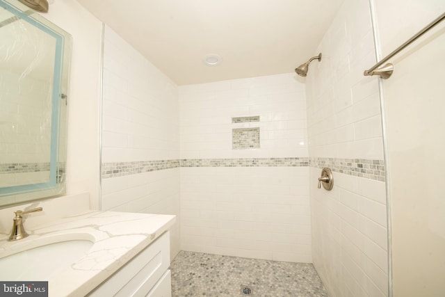 bathroom featuring vanity and a tile shower