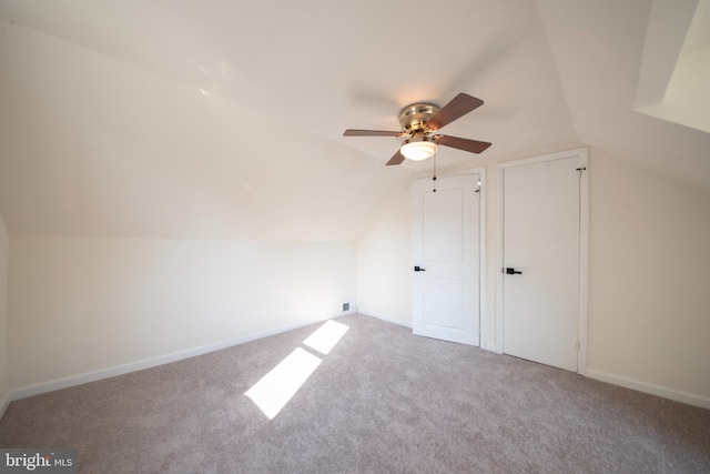 bonus room with vaulted ceiling, carpet flooring, and ceiling fan