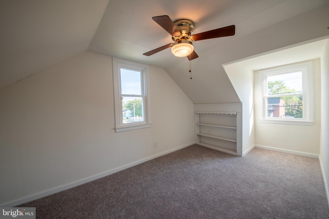 additional living space featuring lofted ceiling, carpet, and ceiling fan