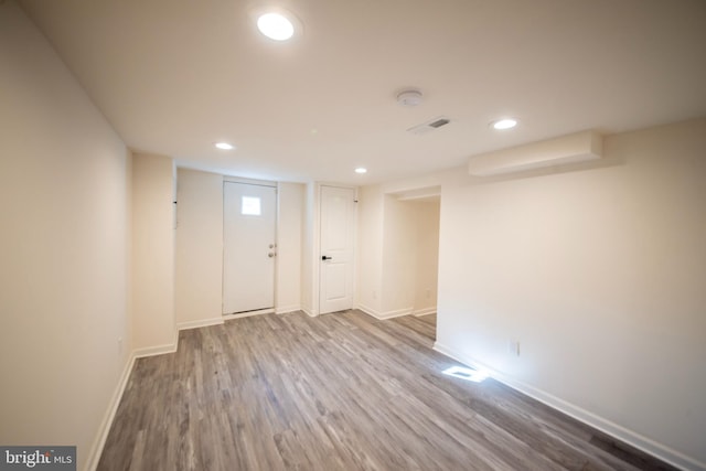 basement with hardwood / wood-style floors