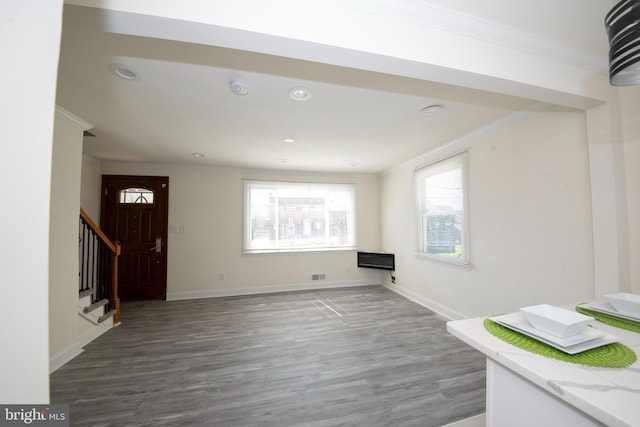 interior space featuring ornamental molding and hardwood / wood-style floors