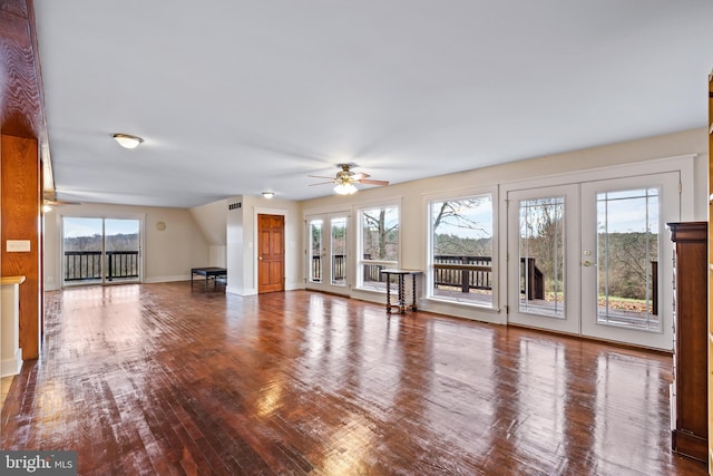 unfurnished living room with ceiling fan and wood-type flooring