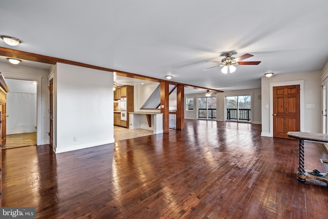 unfurnished living room featuring hardwood / wood-style floors and ceiling fan