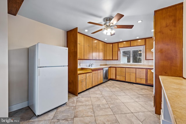 kitchen with white refrigerator, ceiling fan, tasteful backsplash, dishwasher, and light tile floors