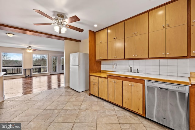 kitchen featuring light wood-type flooring, tasteful backsplash, sink, white fridge, and dishwasher