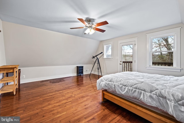 bedroom featuring wood-type flooring, ceiling fan, vaulted ceiling, and access to exterior