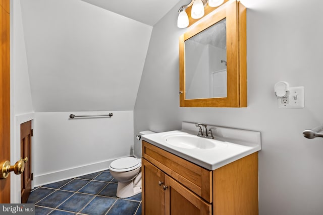 bathroom with vaulted ceiling, vanity, toilet, and tile floors