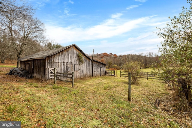 view of shed / structure featuring a rural view and a yard