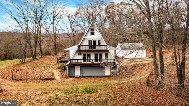 back of property featuring a wooden deck