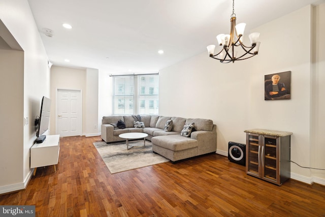 living room with a notable chandelier and dark wood-type flooring