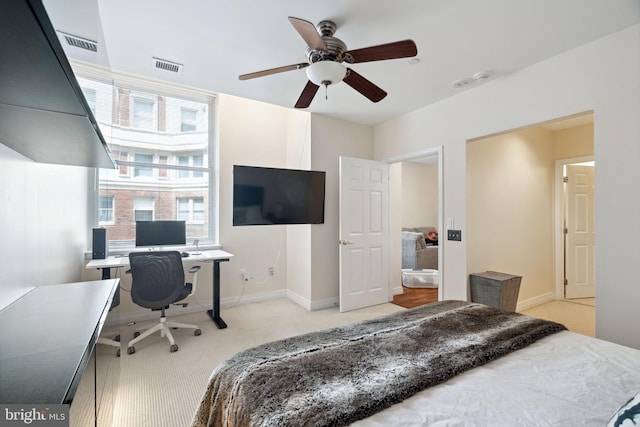 bedroom featuring light colored carpet and ceiling fan