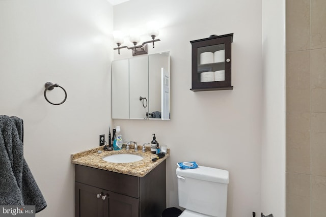 bathroom featuring toilet and vanity