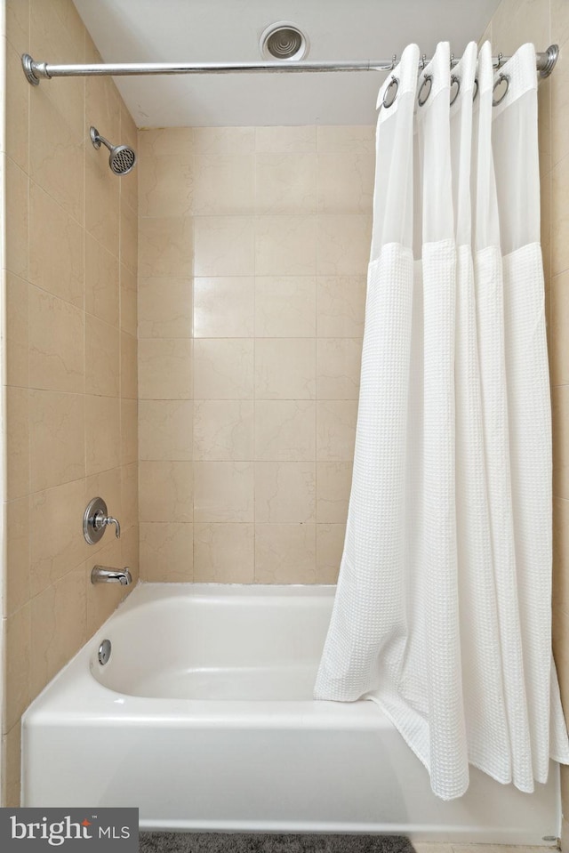 bathroom featuring shower / bath combination with curtain