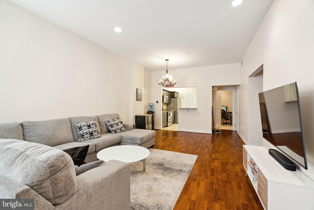 living room featuring dark hardwood / wood-style flooring and a chandelier