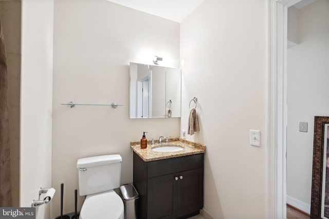 bathroom with toilet and vanity