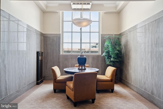 living area with light tile flooring and a high ceiling