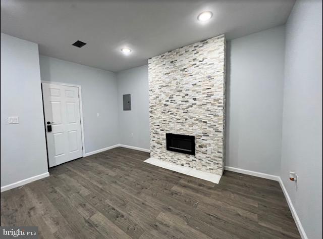 unfurnished living room with a fireplace and dark hardwood / wood-style floors