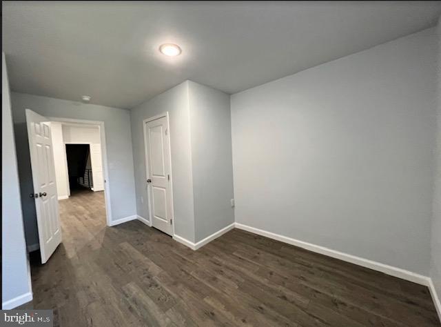 spare room featuring dark hardwood / wood-style flooring