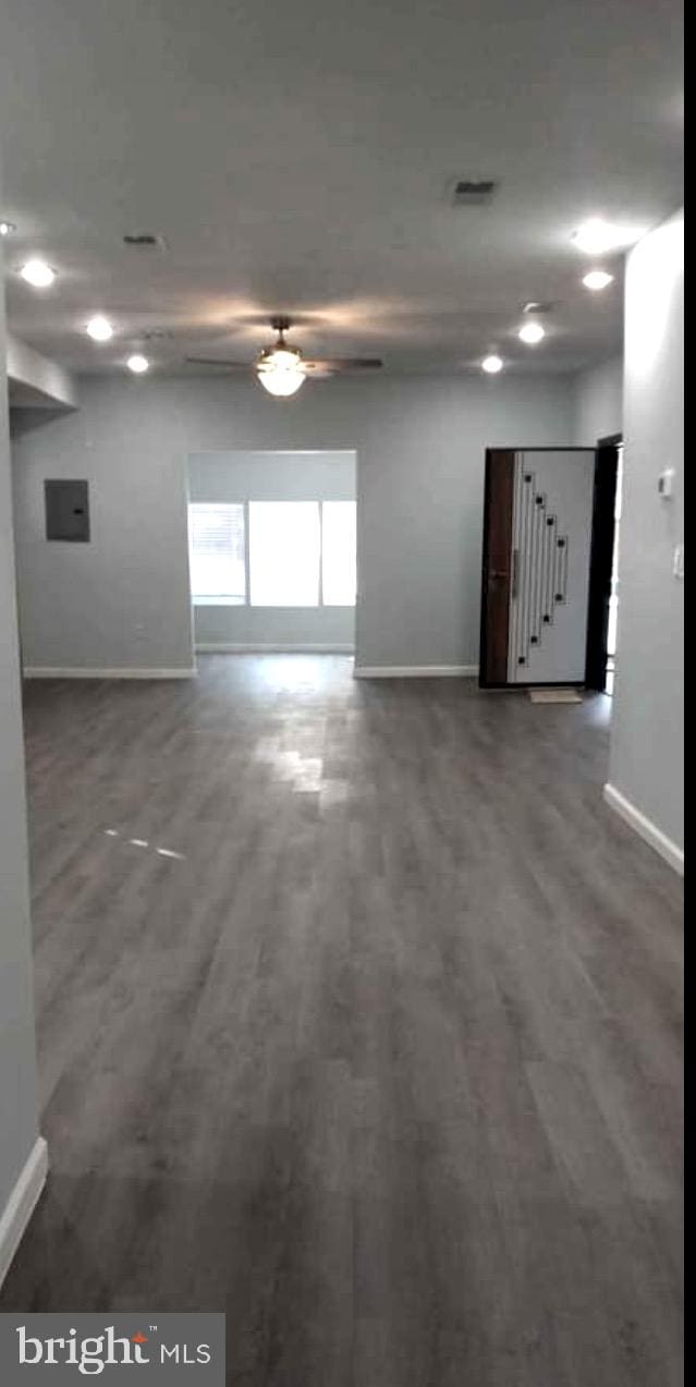 spare room with ceiling fan and dark hardwood / wood-style flooring