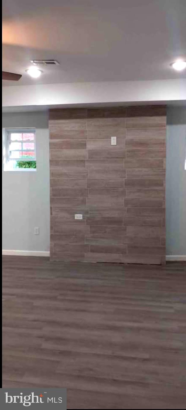 basement featuring dark hardwood / wood-style floors