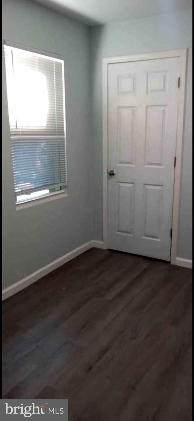 empty room featuring dark hardwood / wood-style flooring