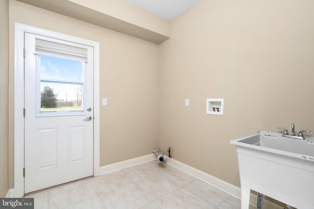 washroom featuring washer hookup, light tile floors, gas dryer hookup, and sink