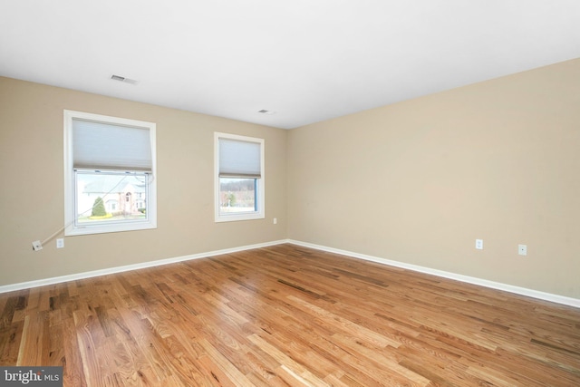 spare room featuring light wood-type flooring