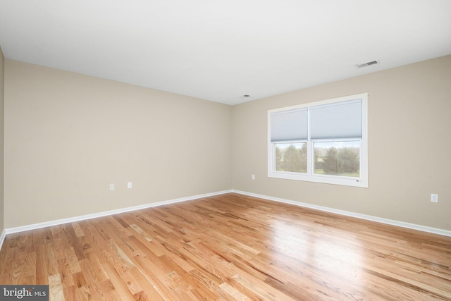 unfurnished room with light wood-type flooring