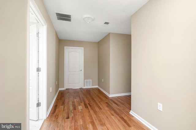 corridor with light wood-type flooring