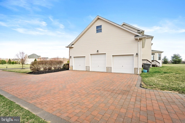 view of home's exterior featuring a yard and a garage