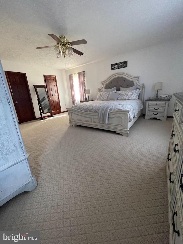 bedroom with light carpet, a textured ceiling, and ceiling fan