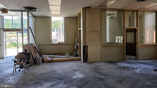 misc room with concrete flooring and a textured ceiling