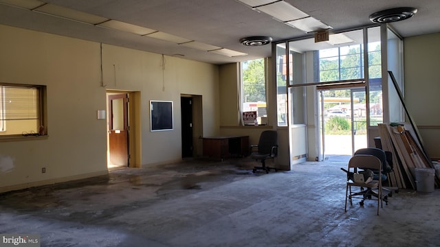 interior space with concrete floors and a high ceiling