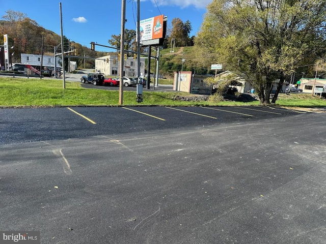 view of car parking featuring a lawn