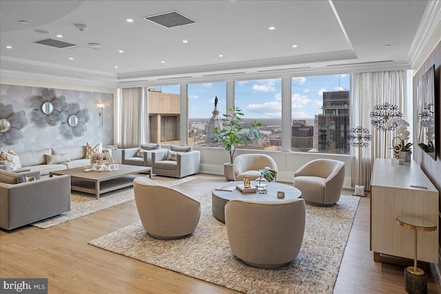 living room featuring ornamental molding and light hardwood / wood-style flooring