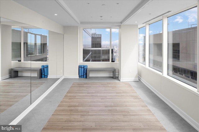 workout room featuring light wood-type flooring