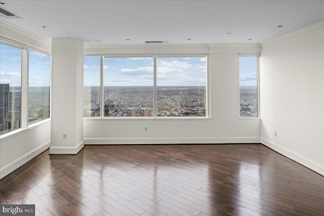 empty room with ornamental molding, dark wood-type flooring, and a wealth of natural light