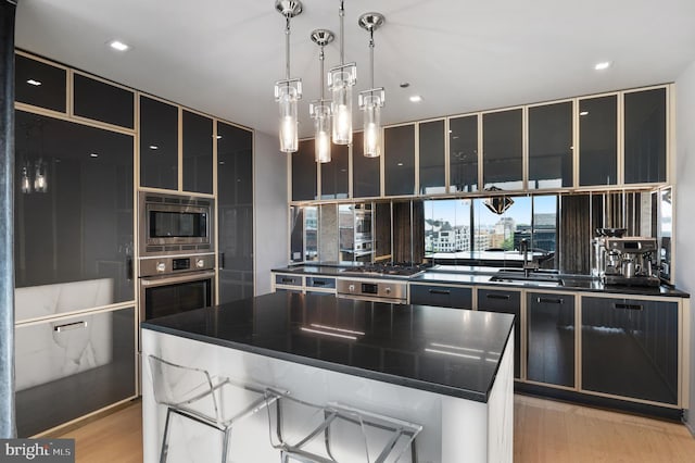 kitchen featuring a kitchen island, a kitchen bar, and appliances with stainless steel finishes