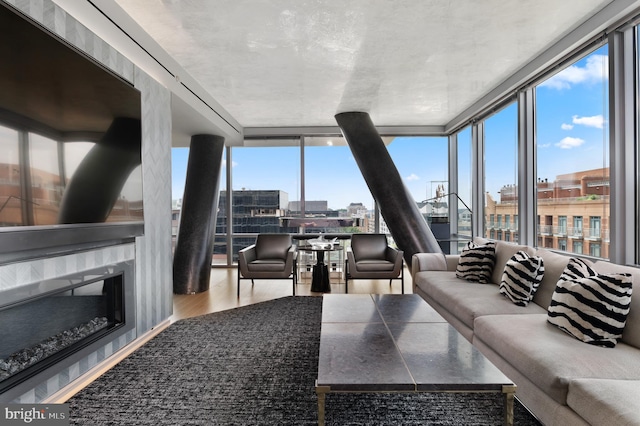 living room featuring floor to ceiling windows and light wood-type flooring