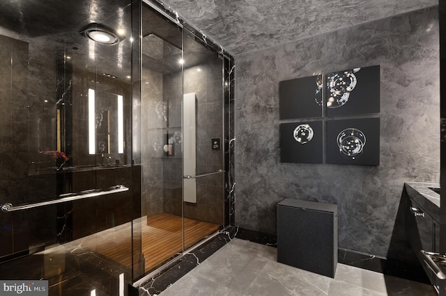 bathroom featuring walk in shower, vanity, and tile flooring