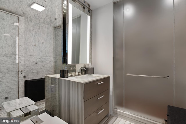 bathroom with walk in shower and vanity