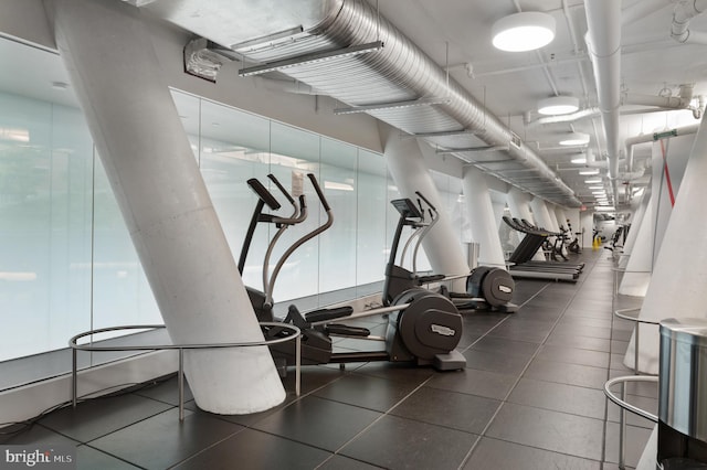 workout area featuring dark tile floors