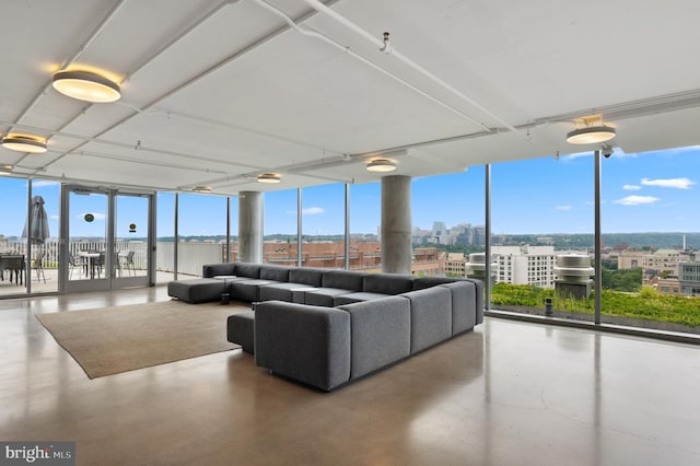 living room featuring concrete floors and expansive windows