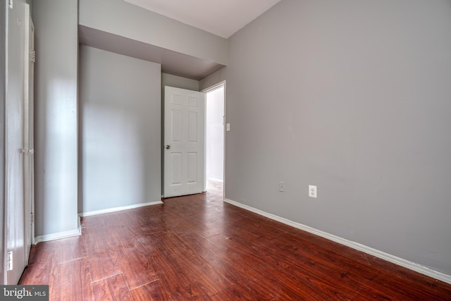 spare room featuring dark hardwood / wood-style flooring