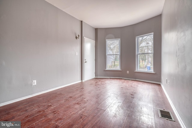 empty room with hardwood / wood-style flooring